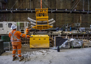 Concrete segments are loaded into the TBM and as the machine excavates forward 1.7 metres, it lifts six segments onto the tunnel’s circular wall. 