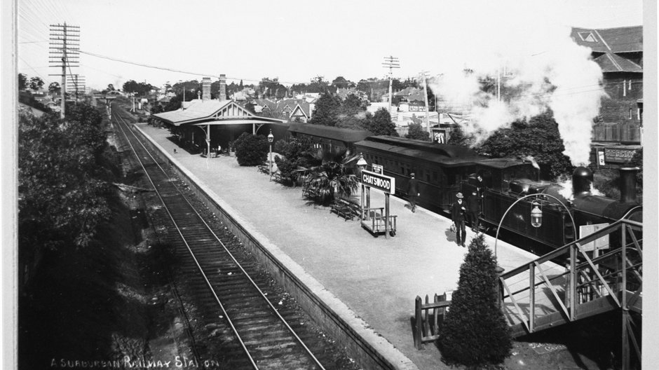 A black and white photo looking down at a station platform as a steam train preparing to depart at Chatswood Railway Station in 1910. 