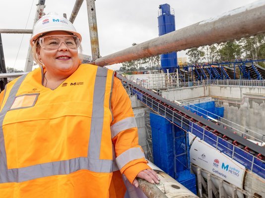 Catherine White standing in a Sydney Metro construction site wearing safety gears