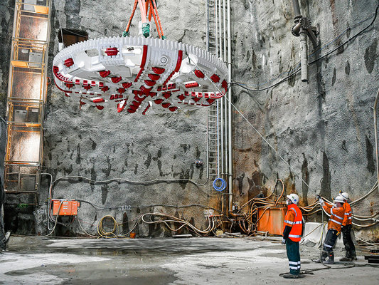 Barangaroo TBM 5 Cutterhead being observed by three construction workers.