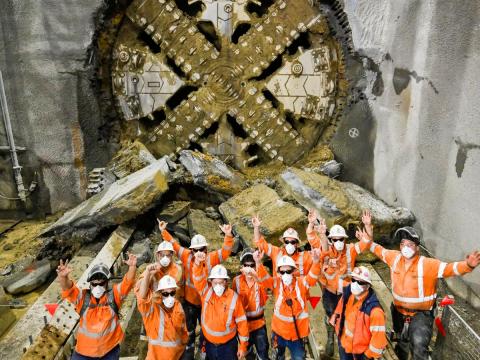 Group of Sydney Metro employees in front of the TBM breakthrough at St Marys