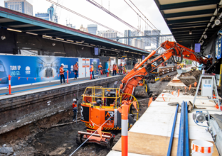 Heavy machinery is being used to reinforce the railway track which is above the future central walk.