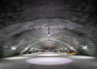 A view from inside the Barangaroo Cavern Plenum looking down the long tunnel that's lit up with spotlights.