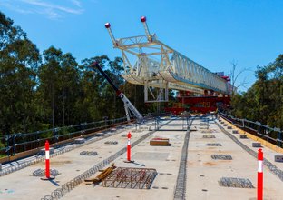 An on the ground view showing the metal structure of the first span of Sydney Metro's skytrain completion.