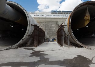 An on the ground view looking into the entrance of the construction of Sydney Metro's twin tunnels, Australia's longest railway tunnels. 