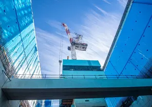 Crane lifting a precast concrete section into the Waterloo Station box