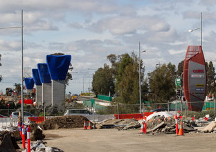 The background of the image shows the segments are in place for the skytrain at Rouse Hill.  The foreground shows the site where the rest of the segments will go.