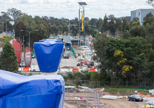 An above the ground view from one of the concrete pillars showing the construction site at Sydney Metro's Rouse Hill Station.