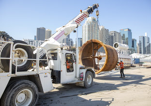An on the ground view of a truck lifting the Bucket for Access Shaft at Sydney Metro's Barangaroo site. 