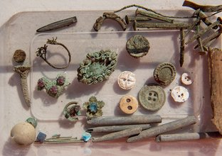 A close up of some of the old artefacts that were found at Blues Point construction site. Buttons, nails and screws are amongst the items found.
