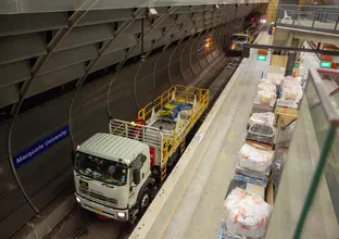 An arial view showing two trucks on the tracks delivering materials to the platform at East Coast Rail Link's Macquarie University Station.