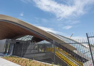 A street-level view of the outside of Bella Vista Station with lifts in view down to the platform. 