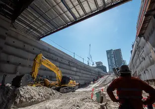 An on the ground shot as a construction worker is inspecting the excavation work at Sydney Metro's Crows Nest Station. 