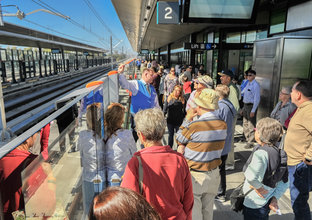 A crowd of people are on Rouse Hill Station platform waiting for the platform screen doors to open on Community Day.