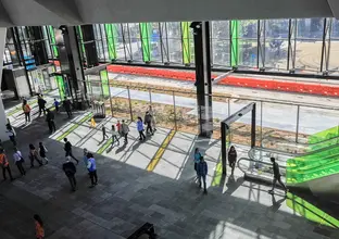 A wide angle view of people in the concourse of Rouse Hill Station.