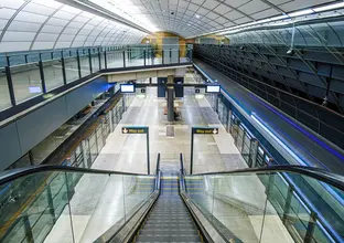 A view from above looking down the escalators at the completed platform at Sydney Metro's Macquarie University Station.