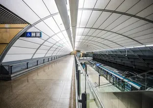 An artist's impression inside of the raised platform side walk showing the platform below as a Sydney Metro train pulls up to North Ride Station platform. 