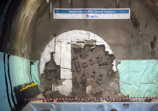 The cutterhead of a tunnel boring machine can be seen breaking through the wall at Pitt Street Station
