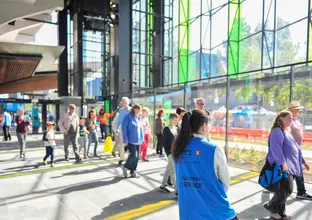 A crowd of community members walking through Rouse Hill Station on Community Day.