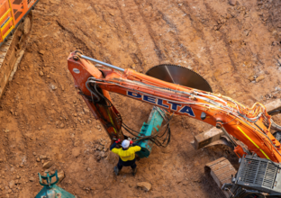 A bird's eye view of a man operating an excavator at the north site of Sydney Metro's Martin Place Station.