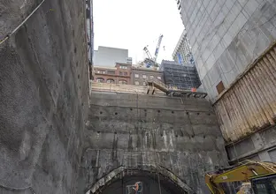 Heavy machinery are working inside the pit of Pitt Street South construction site.