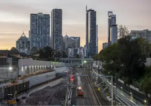 Northern Connection construction site at dusk. There are buildings in the background