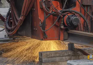 Machinery welding rail track at Waterloo Station. Sparks can be seen underneath the machine