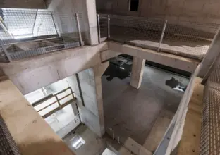 A view from above looking down into the Chatswood Dive cassette structure. Metal fencing protects workers from falling down.