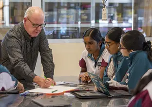 Sydney Metro representative working with students at Catherine McAuley School for Metro Minds