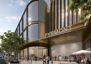 Artist's impression of the new Pyrmont Station as viewed from street level outside while commuters walk around and into the station.