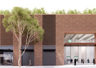 Artist's impression of Crows Nest Station entrance which is in a red brick building with a tree in front.