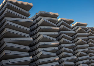 Five piles of concrete precast are neatly stacked on top of each other. 