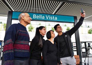 Passengers taking a selfie in front of the Bella Vista sign at Sydney Metro's new station as part of the Bella Vista Community Day. 