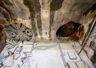 An aerial view into the cavern where two TBMs (tunnel boring machines) have broken through the cavern wall to make way for train tunnels.