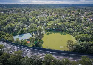 An artist's impression showing a bird's eye view of the oval, basketball courts and tennis next to the highway at Cheltenham. 