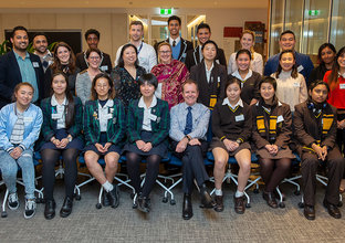 A group photo of Sydney Metro's mentors and student mentees posing while smiling in a boardroom.