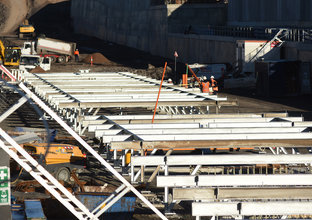 Steel beams being reinforced above the concrete platform canopy at Sydney Metro's Cudgegong Road Station. 