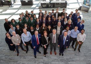 A group photo of Sydney Metro staff members with Metro Minds school participants at the Metro Minds finals in 2018.