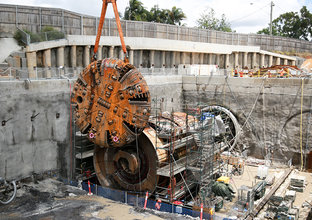 An arial view looking down at the cutterhead of Tunnel Boring Machine (TBM) 1 Elizabeth being assembled at the construction site at Sydney Metro's Cherrybrook Station. 
