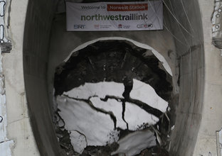 An on the ground view showing Tunnel Boring Machine (TBM) 2 Florence breaking through the stone that is shattering to the ground at Sydney Metro's Hills Showground Station as part of the North West Rail Link project. 