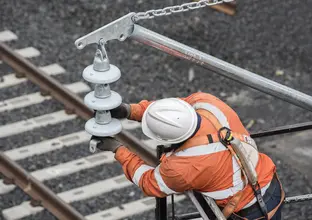 Construction worker moving materials into place as tracks are being laid on Sydney Metro's Northwest project. 