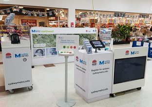 Sydney Metro branded information pop up is pictured inside a Westfield in front of a Coles.