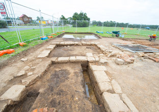 The White Hart Inn archaeological site is fenced off from the field surrounding it.