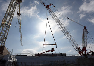 Two cranes in operation at Bella Vista Station construction site on a sunny day.