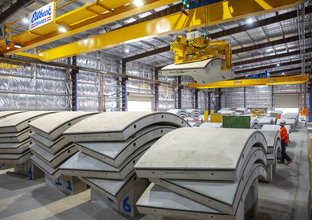 A view inside the Marrickville precast factory where several concrete precast structures are piled up on top of each other.