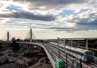 An arial view of a Sydney Metro train being tested on the completed tracks at Windsor Road Bridge. 