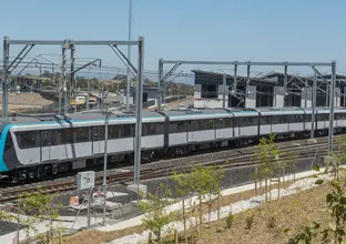 An arial view looking at a Sydney Metro train being tested along the tracks. 