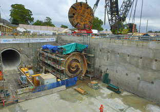 Wide angle shot of the retrieval site for TBM2 Florence. The cutterhead is being removed from the site by a crane.