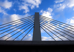 Windsor Road bridge triangular supports against the backdrop of a blue sky with clouds.