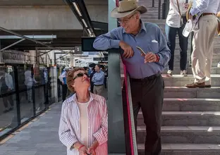 A woman looks up at a man standing on the steps of Cherrybrook Station platform during Cherrybrook Community Day.